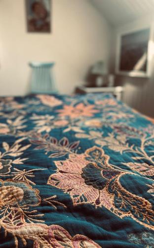 a close up of a bed with a blue rug at Charming rooftop apartment in Uhre in Brande