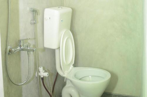 a bathroom with a toilet and a shower at Sun Up Hotel in Katunayake