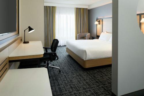 a hotel room with a bed and a desk at Fairfield Inn & Suites by Marriott Montreal Airport in Dorval