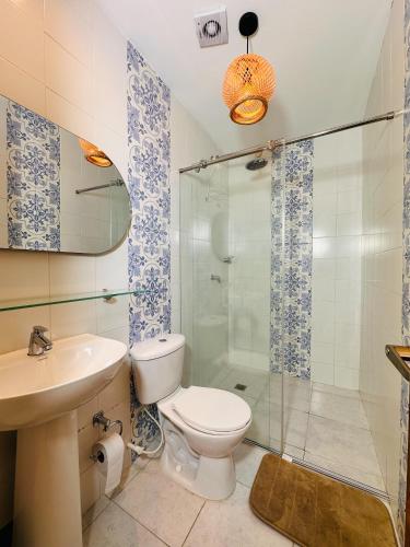 a bathroom with a toilet and a shower and a sink at Hostal Casa Torres Centro Historico - Adults Only in Cartagena de Indias