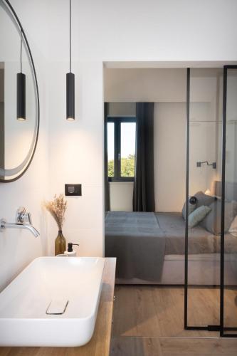 a bathroom with a sink and a bed at Villa TonKa with jacuzzi sauna and private pool in Labin