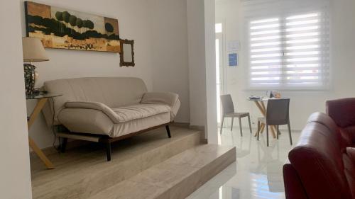 a living room with a chair and a table at B&B Passione Salento in Surbo