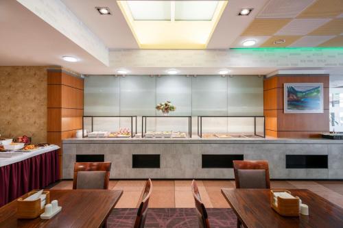 a restaurant with tables and chairs and a counter at Art City Inn in Vilnius