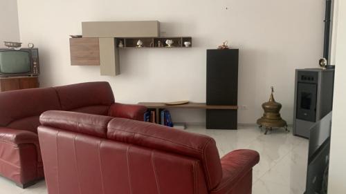 a living room with a couch and a tv at B&B Passione Salento in Surbo