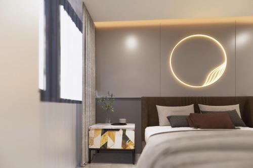 a bedroom with a bed and a mirror on the wall at Vina Apartment- Căn hộ trung tâm Huế in Thôn Trường Giang