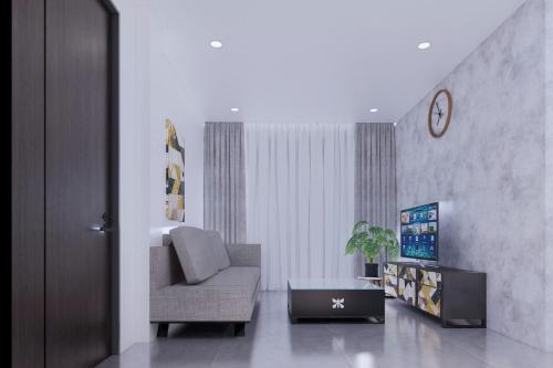a living room with a chair and a tv at Vina Apartment- Căn hộ trung tâm Huế in Thôn Trường Giang