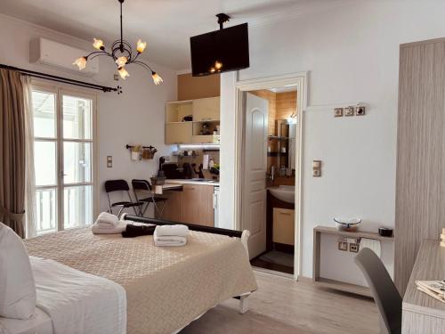 a room with a bed and a kitchen with a table at Orama Milos in Adamas