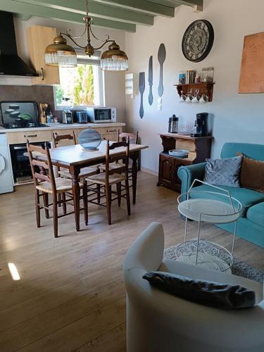 une cuisine et un salon avec une table et des chaises dans l'établissement Les biches, à Saint-Michel-de-Double