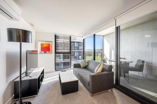 a living room with a couch and a table at Self-Contained Apartment in Woden By Serain in Phillip