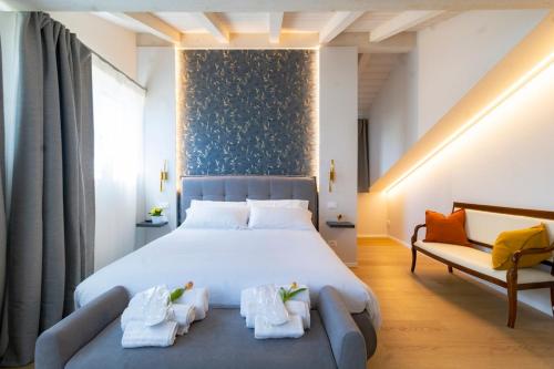 a bedroom with a large bed and a couch at 650m from the sea, 8 guests, AC, Wi-Fi in Civitanova Marche