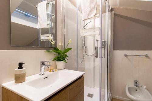 a bathroom with a sink and a shower at 650m from the sea, 8 guests, AC, Wi-Fi in Civitanova Marche