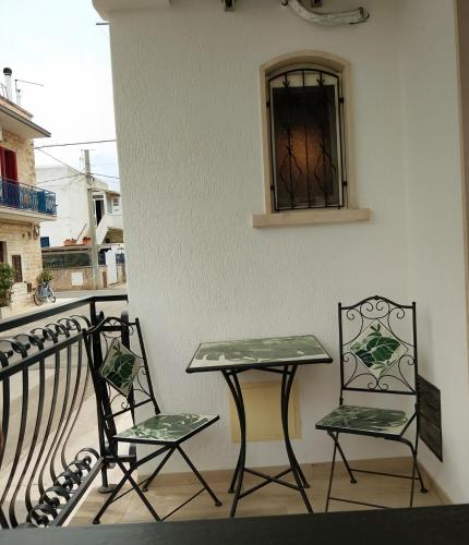 two chairs and a table on a balcony at Dimora Egnazia in Savelletri di Fasano