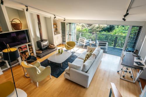 a living room with a couch and a table at Te Kereru, Onetangi in Waiheke Island