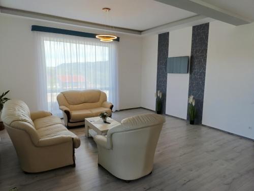 a living room with two chairs and a couch at Vila President Sovata in Sovata