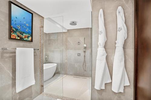 a bathroom with a shower and a sink at Kempinski Seychelles Resort in Baie Lazare Mahé