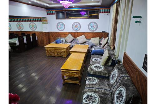 a living room with a couch and a table at Greater Ladakh Residency in Leh