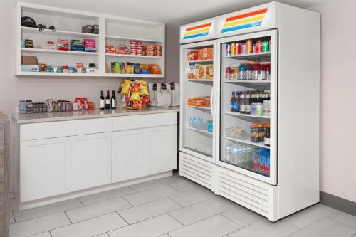 a white refrigerator with its door open in a kitchen at Ramada by Wyndham Milwaukee in Milwaukee