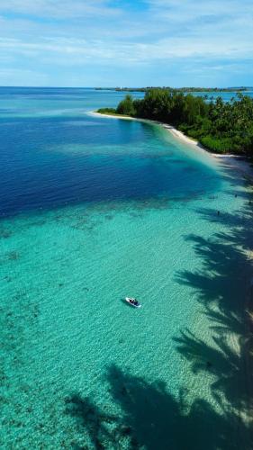 an aerial view of a beach with a boat in the water at Kimo Resort Pulau Banyak Aceh Singkil in Alaban