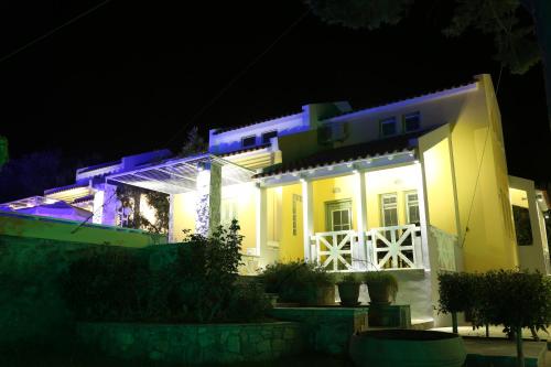 a house lit up at night with blue lights at Sea Sun in Plomarion