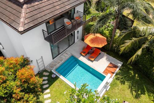an overhead view of a swimming pool next to a house at Khwan Beach Resort - Luxury Glamping and Pool Villas Samui - Adults Only - SHA Extra Plus in Mae Nam