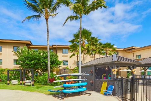 a building with palm trees and a playground at Courtyard by Marriott Oahu North Shore in Laie