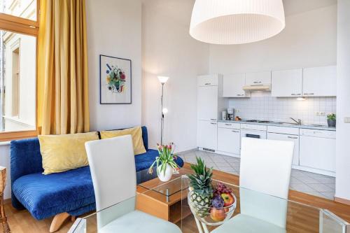 a living room with a blue couch and a table at Haus Zander in Heringsdorf