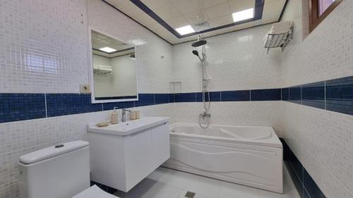 a bathroom with a toilet and a sink and a tub at Grandview Boutique Hotel in Baku