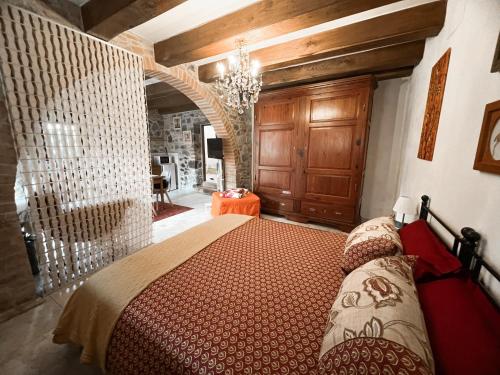 a bedroom with a bed and a chandelier at L' antico lavatoio in Radicofani
