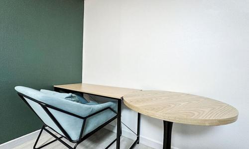 a table and a chair next to a table at Gumi time hotel in Gumi