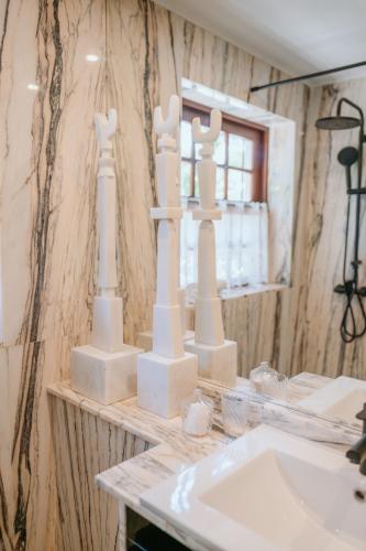 a bathroom counter with white chess pieces on it at Casa das Figuras in Sintra