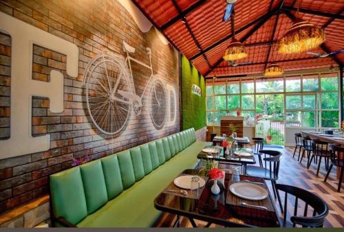 a restaurant with tables and chairs and a brick wall at Maya resort in Jāmb