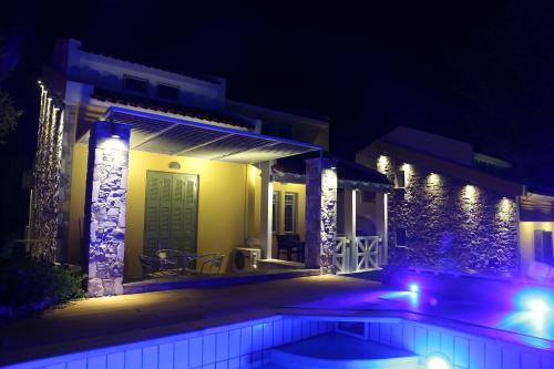 a house with a swimming pool at night at Sea Sun in Plomarion