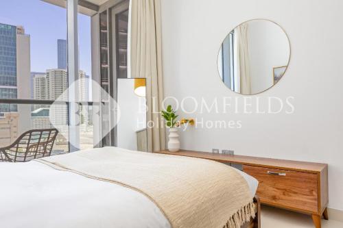 a bedroom with a mirror and a bed at Bloomfields 1BR Elegant in Shams Meera in Abu Dhabi