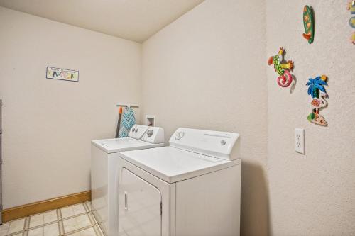 a laundry room with a washer and dryer at 3050 - Whispering Pines in Southern Shores