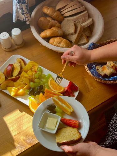 a table with a plate of bread and a plate of food at Penzion Muštelka in Rokytnice nad Jizerou