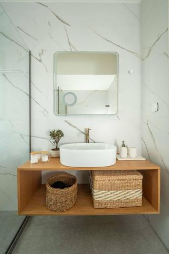 a bathroom with a sink and a mirror at Esatia Villa in Exanthia