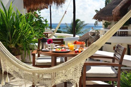 a table with a plate of food on a patio at Playa Palms Beach Hotel in Playa del Carmen