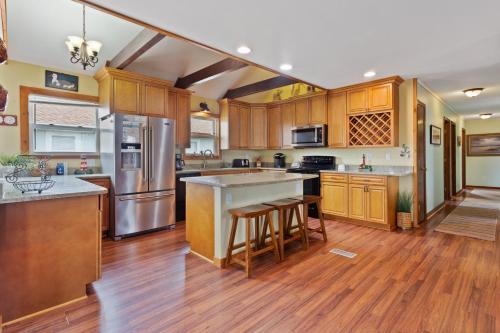 a kitchen with wooden cabinets and stainless steel appliances at 6090 - Seas The Day NH in Nags Head