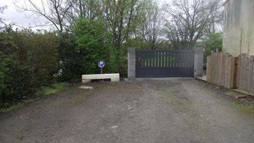 a blue gate with a bench in front of it at Chambre,petit déjeuner inclus in Chantonnay