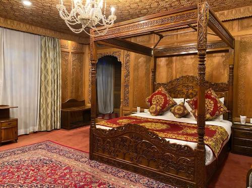 1 dormitorio con cama con dosel y lámpara de araña en The Heritage Group Of Houseboats, en Srinagar