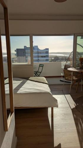 a bedroom with a bed and a view of a building at Penthouse Studio Sea View in Alvor