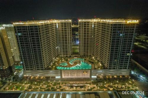 a large building with a pool in front of it at night at Midori Park The Glory Căn hộ 2 phòng ngủ tại Thành phố Mới Bình Dương in Thu Dau Mot