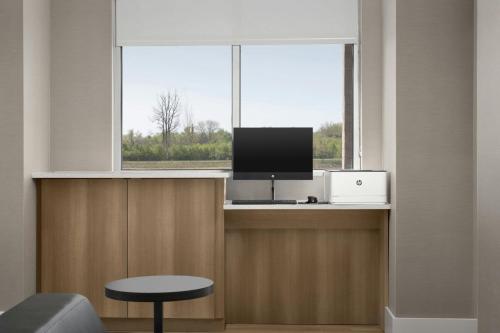 a room with a window with a computer and a tv at Residence Inn by Marriott Dayton Miamisburg in Miamisburg