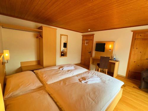a bedroom with a large bed in a room at Madrisa Lodge in Klosters