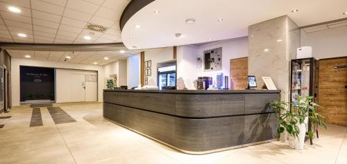 a lobby of a store with a cash counter at Hotel Szieszta in Sopron