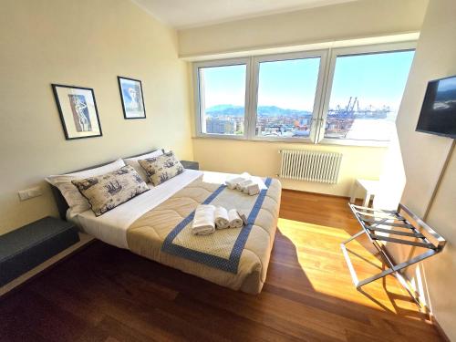 a bedroom with a bed with towels on it at Appartamento Decimo Cielo Vista Mare in La Spezia
