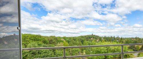 a view of a forest from a window at Hotel Szieszta in Sopron