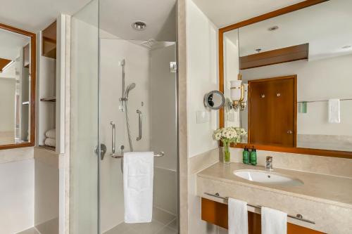 a bathroom with a sink and a shower at Shangri-La Chiang Mai in Chiang Mai