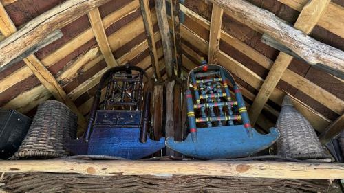 two machines hanging from the ceiling of a attic at cottage panorama merisi in Inasharidzeebi