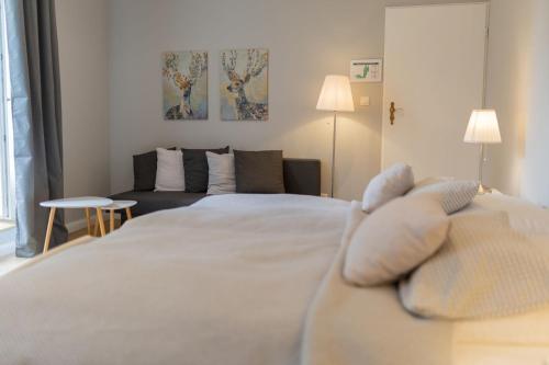 a bedroom with a bed with a teddy bear on it at Gut Basthorst in Basthorst